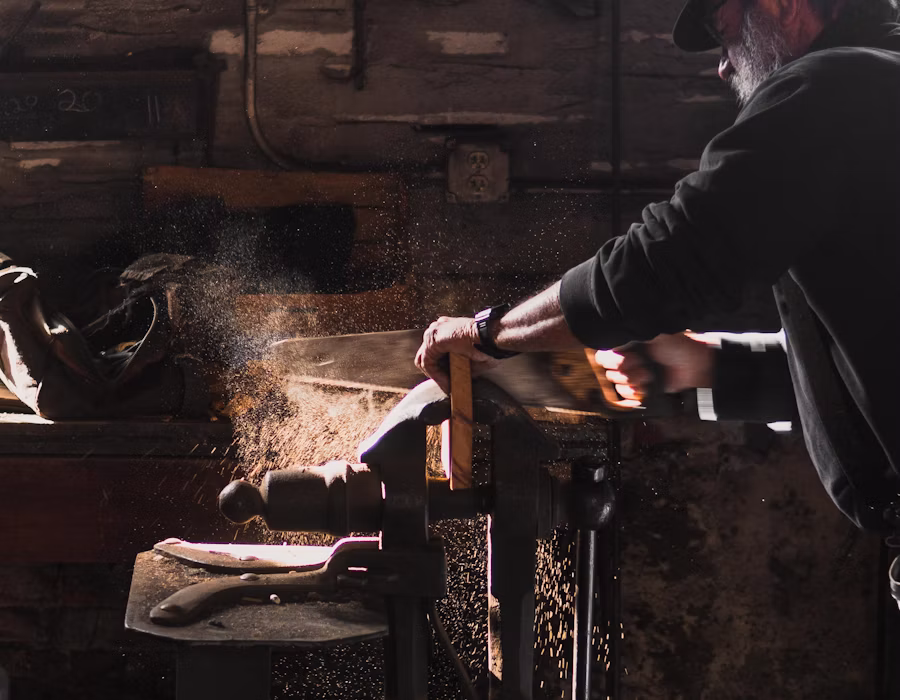 Craftsman hand-planing wood for custom millwork